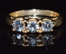 A 9k gold ring set with three green sapphires, 2.7g, size M