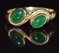 A 14k gold ring set with two jadeite cabochons by Anka, 2.9g, size N
