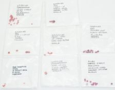 Twelve square cut loose rubies and fifty six loose red sapphires