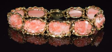 A 14k gold bracelet set with carved floral coral panels, 19cm long, 14.4g