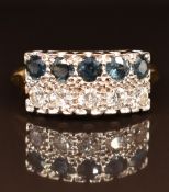 An 18ct gold ring set with diamonds and sapphires in a platinum setting, each stone approximately