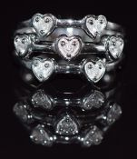 A 9k white gold ring set with diamonds in heart settings, 6.6g, size N