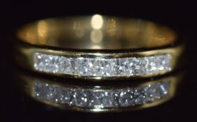 An 18k gold half eternity ring set with nine princess cut diamonds totalling approximately 0.6ct,1.