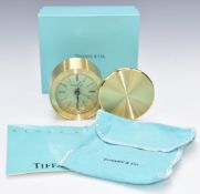 Tiffany and Co circular travelling or desk clock with swivel cover, in original box with cloth bag