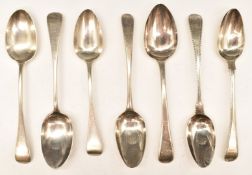 Seven Georgian and later hallmarked silver Old English pattern dessert spoons, two having feather