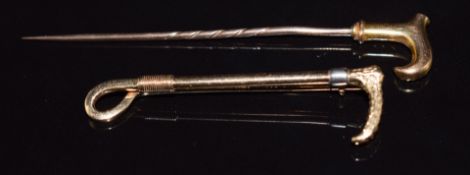 A 9ct gold and platinum brooch in the form of a riding crop (2.9g) and a 9ct gold stick pin in the