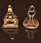 Two intaglio seals, one carved with a dove reading 'peace' and the other a cherub with a heart