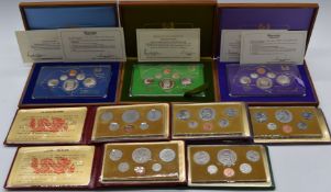 Eight Singapore proof coin sets to include 1976, 1977, 1978, in wooden deluxe cases or in