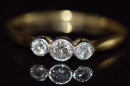 An 18ct gold ring set with three diamonds in a platinum setting, 2.2g, size Q