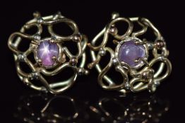 A pair of 9ct gold earrings set with star ruby cabochons, 5.7g