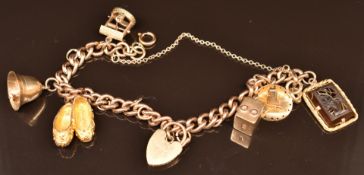 A 9ct gold charm bracelet with five 9ct gold charms including bell, shoes, hat, etc, 45.8g