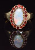 A 9ct gold ring set with an opal and garnets, 3.5g, size N