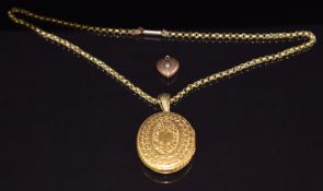 Victorian yellow metal locket with engraved decoration (3.5 x 2.8cm) and an Edwardian 9ct gold heart
