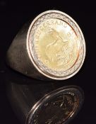 A 9ct gold ring set with a 1982 1/10 Krugerrand, 7g, size J