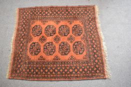 Turkoman rug with orange ground and blue decoration, 185 x 155cm