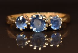 An 18ct gold ring set with three cushion cut sapphires, 3g, size O