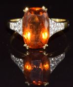 An 18ct gold ring set with an oval cut citrine and diamonds, 6.2g, size S