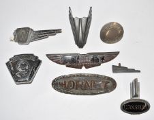 Seven Wolseley pre war car badges and mascots to include Hornet and 9, length of longest 15cm