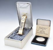 Royal Mint Battle of Britain silver proof medallion, weight 50g, and a miniature Estyma longcase