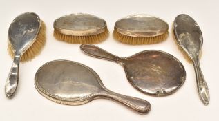 Hallmarked silver mounted dressing table items comprising two hand mirrors and four various brushes