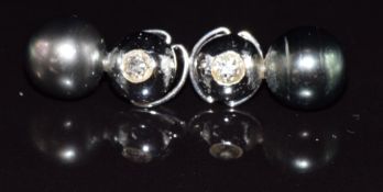 A pair of 18ct white gold earrings each set with an old cut diamond of approximately 0.3ct and a