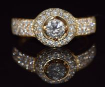 An 18ct gold ring set with a diamond of approximately 0.35ct with diamond encrusted surround and