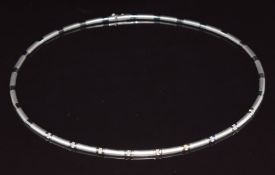 A 18ct white gold necklace made up of smooth and matt links, set with nine diamonds each