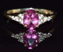 A 9ct gold ring set with a synthetic pink sapphire and white sapphires, 2.2g, size R