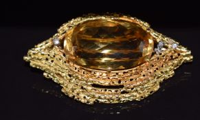 A 1970's 18ct gold brooch set with a large mixed oval cut citrine and diamonds by Ernest A Blyth,