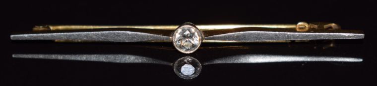 An 18ct gold brooch set with a diamond measuring approximately 0.2ct, with platinum finish