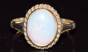 A 9ct gold ring set with an opal cabochon, 2.4g, size P