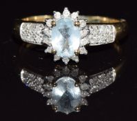 A 9k gold ring set with an oval cut aquamarine surrounded by diamonds, 2.5g, size Q