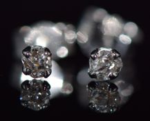 A pair of 18ct white gold earrings set with a round cut diamond to each