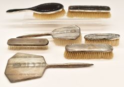 Hallmarked silver mounted dressing table items comprising hand mirror and six various brushes,