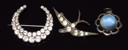 Two Victorian paste brooches, a crescent and swallow and a silver pendant set with a moonstone