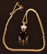 A 9k gold pendant set with smoky quartz and diamonds, 4.8g, 44cm long