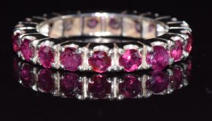 An 18ct white gold eternity ring set with rubies, each approximately 0.1ct, 4.3g, size N