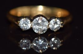 An 18ct gold ring set with three diamonds the centre diamond of approximately 0.25ct, 2.5g, size I
