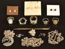 A collection of silver jewellery including moonstone, labradorite and moss agate rings, bee