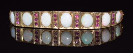 Art Deco 9ct gold bracelet set with rubies and opal cabochons, 18cm long, 14g