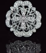 A 9k white gold ring set with diamonds in a pierced setting, 6.8g, size M