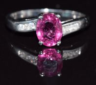A 9k white gold ring set with an oval cut rubellite and diamonds, 2.9g, size Q