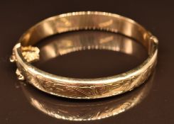 A 9ct gold bangle with engraved decoration, 13.3g, 6 x 5.5cm