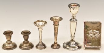 Hallmarked silver items comprising candlestick, smaller pair of candlesticks, two trumpet vases