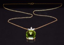 An 18ct gold necklace set with an emerald cut peridot of approximately 12cts and three marquise