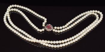 A double strand of cultured pearls, the 9ct gold clasp set with rubies and diamonds, 56cm long