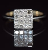 An 18ct white gold ring set with princess cut diamonds in a square setting, 3.6g, size K