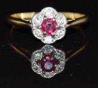 An 18ct gold ring set with a ruby and diamonds in a platinum setting, 2.3g, size N