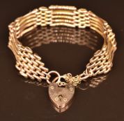 A 9ct rose gold gate bracelet with heart padlock clasp, 13.1g