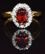 An 18ct gold ring with a garnet and diamonds, 4.1g, size K